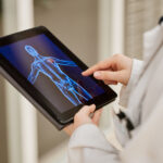 doctor hands and tablet x ray mri results and healthcare research anatomy solution and injury re