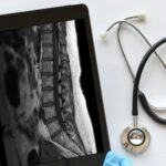 doctor medical professional technician using a ipad tablet to view read mri results e1699546450506